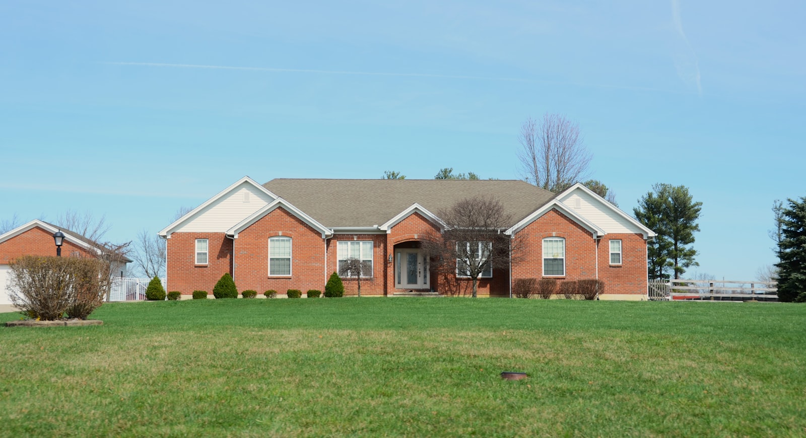 Red-brick Richardson home with a freshly cut, edged front lawn.